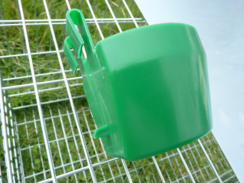 Cage feeding or drinking cup easily clips onto cage